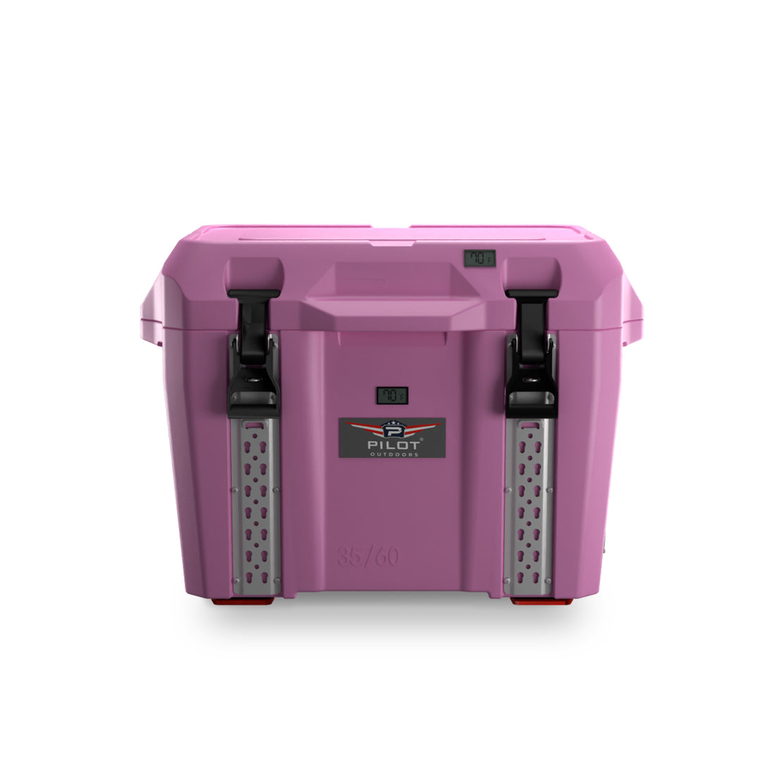 Compact pink portable cooler with hinged lid, side handles, and front thermometer, against white background.