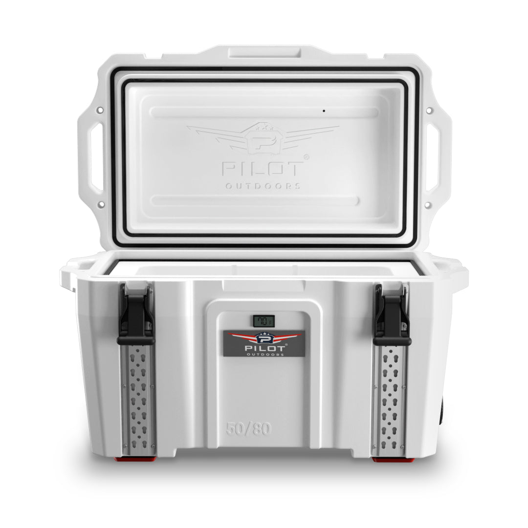 Pilot Outdoors white rotomolded cooler with open lid, black latches, and front logo showing temperature display.