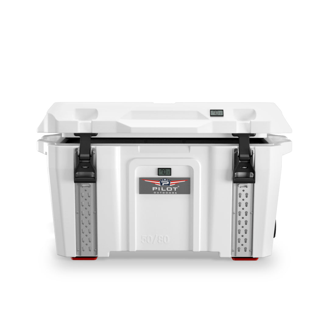 Pilot Outdoors white rotomolded cooler with open lid, black latches, and front logo showing temperature display.